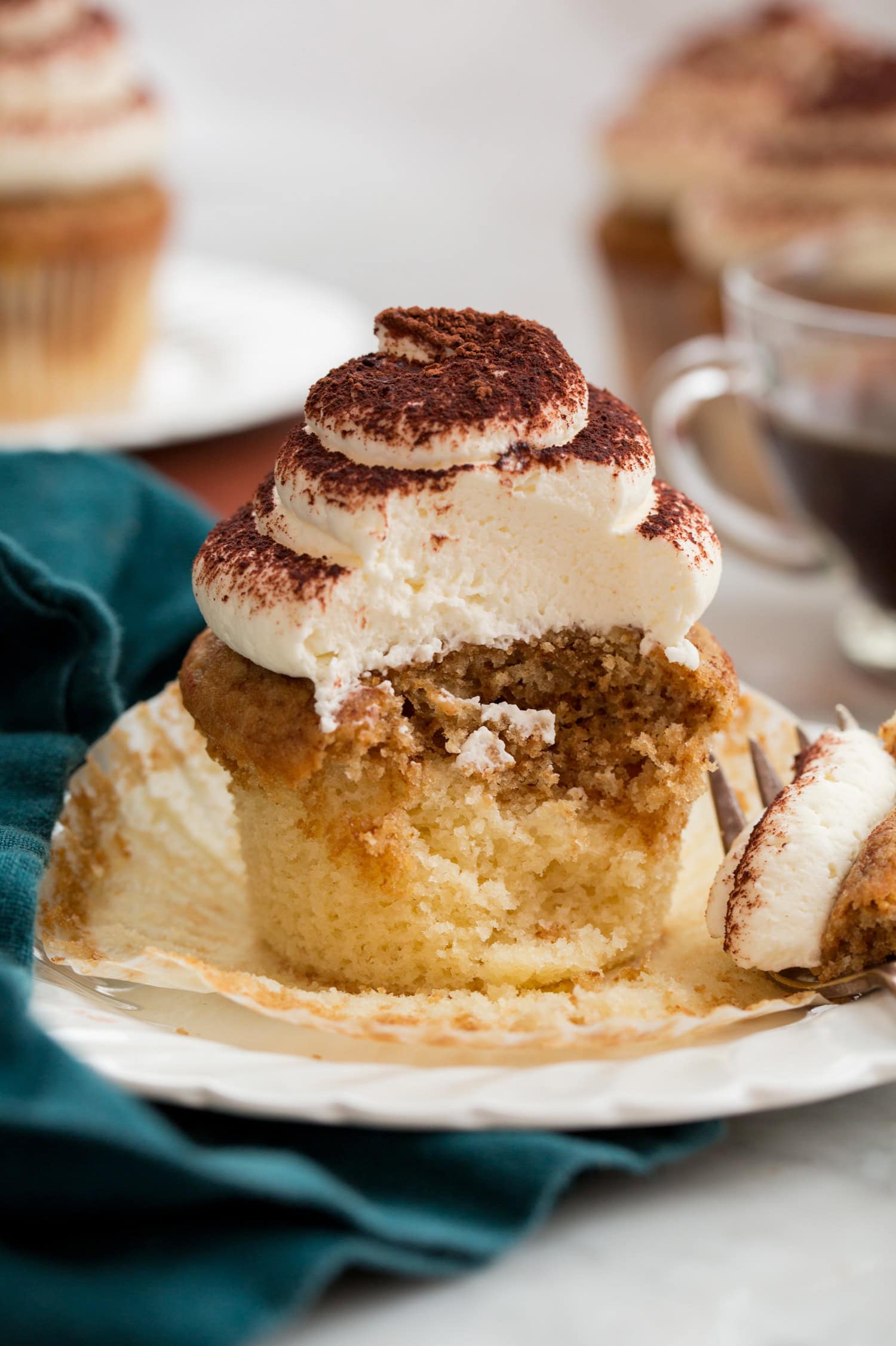 Tiramisu Cupcakes cut into showing interior with soft moist crumb and two layers of flavors.