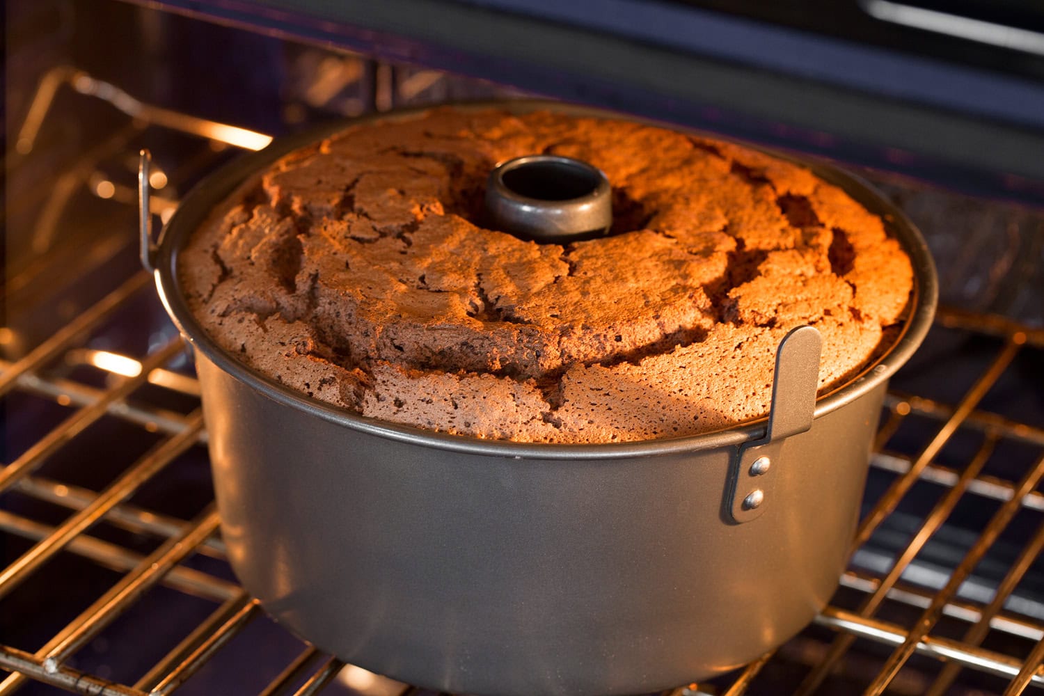 Angel food cake pan in oven baking.