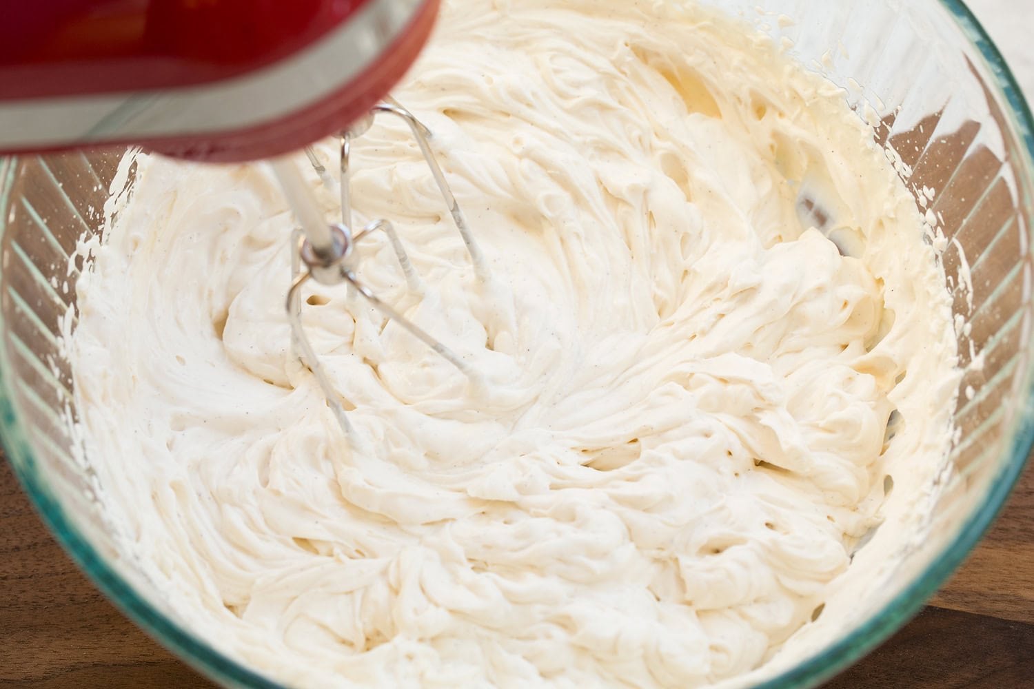 Yogurt mixture after whipping with hand mixer in mixing bowl.