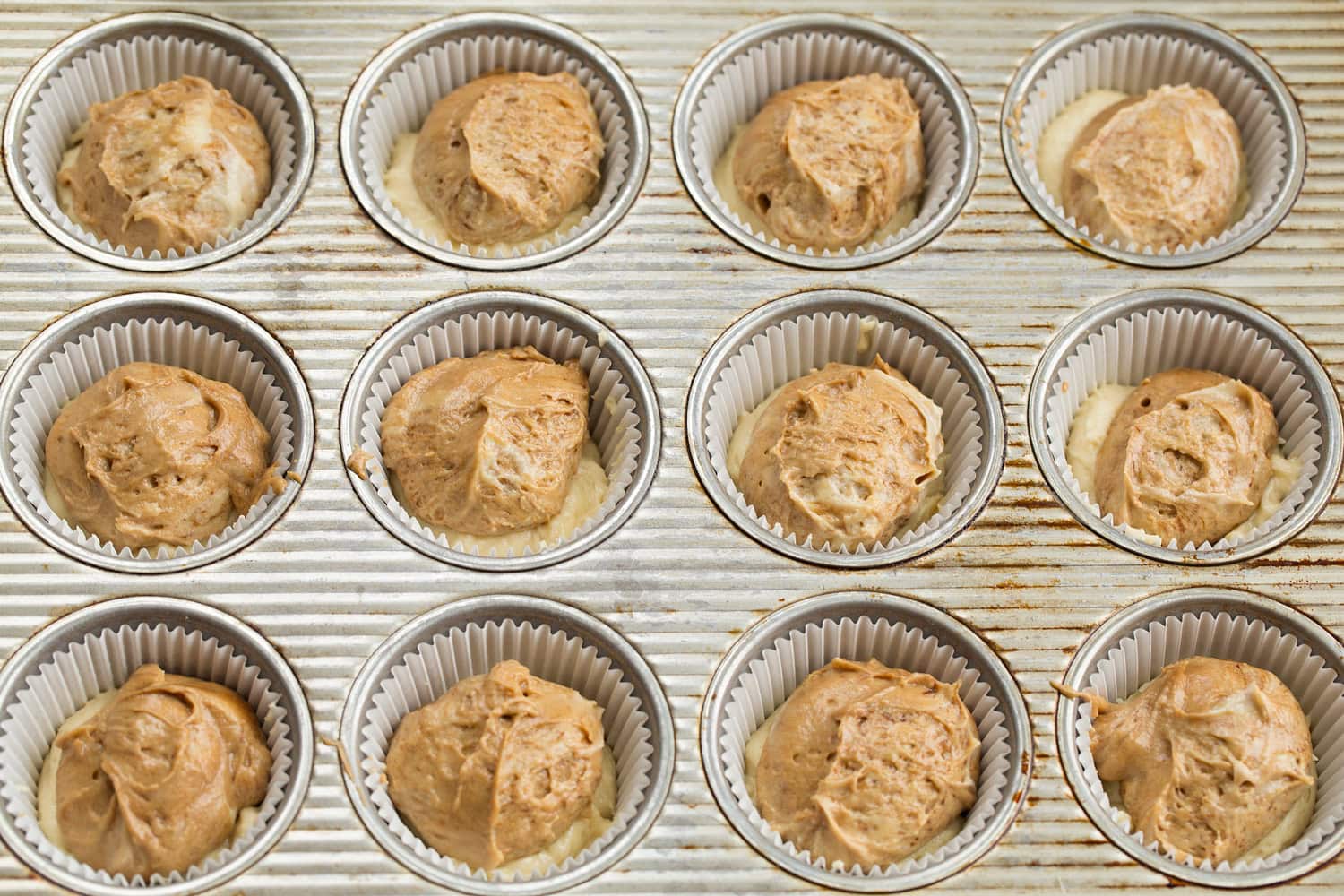 Espresso cupcake batter added to muffin pan.