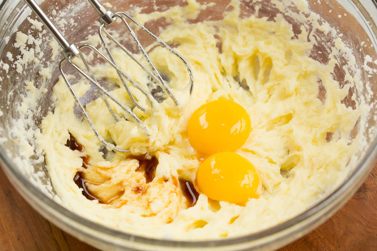 Egg yolks and vanilla added to cupcake batter.