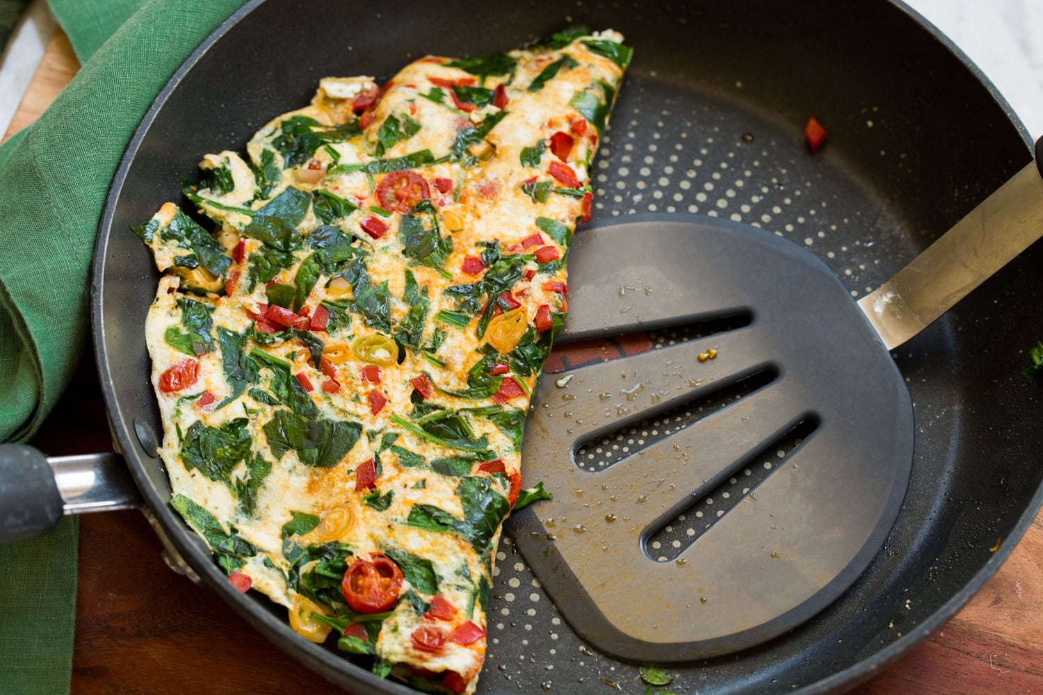 Omelette folded in half in skillet.