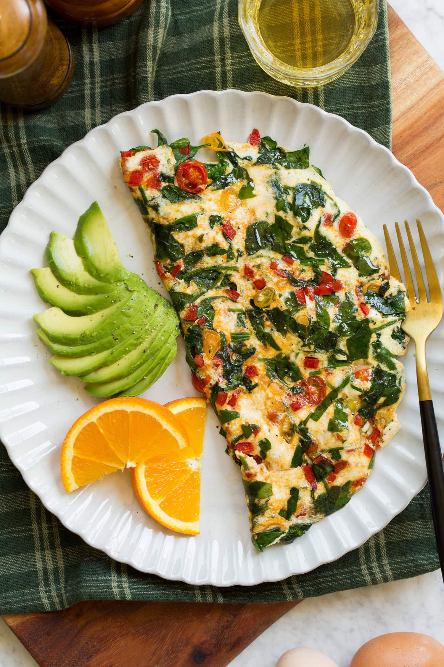Egg white omelette on a scalloped white ceramic plate.