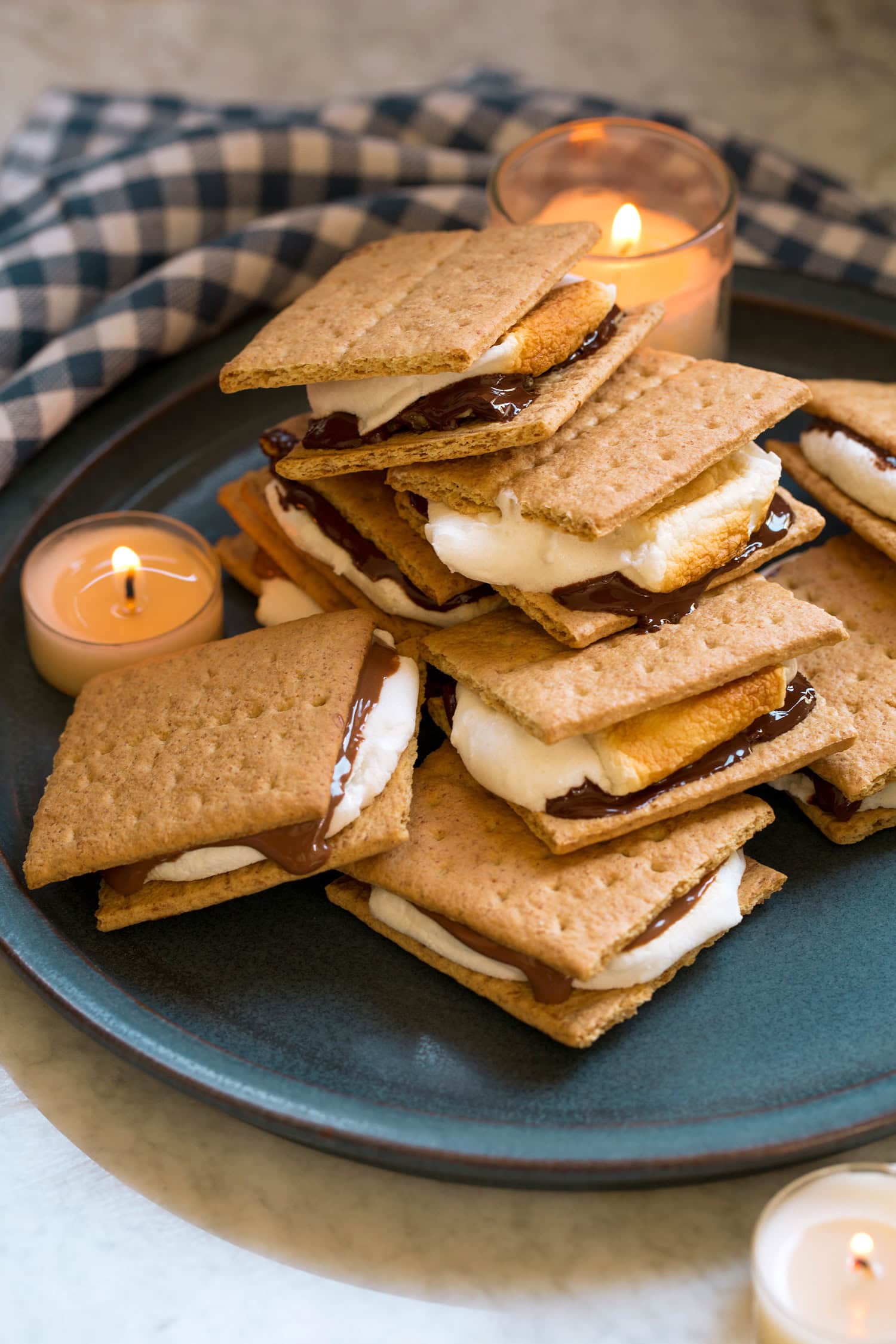 Pile of s'mores with milk chocolate and dark chocolate on a blue plate.