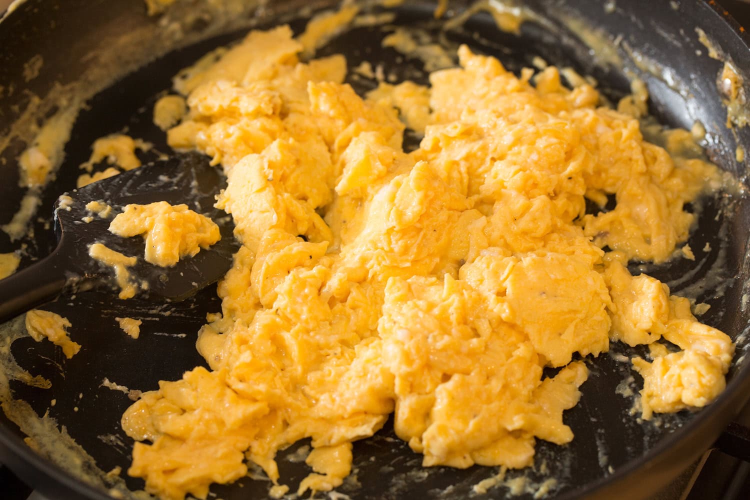 Scrambled eggs finished in skillet.