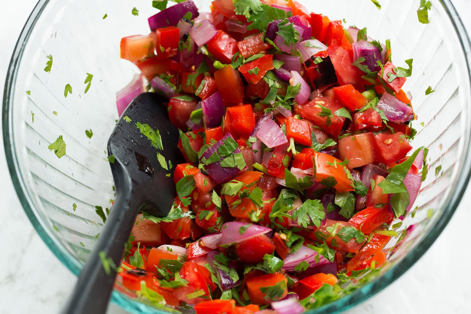 Bell pepper pico tossed together in a mixing bowl.