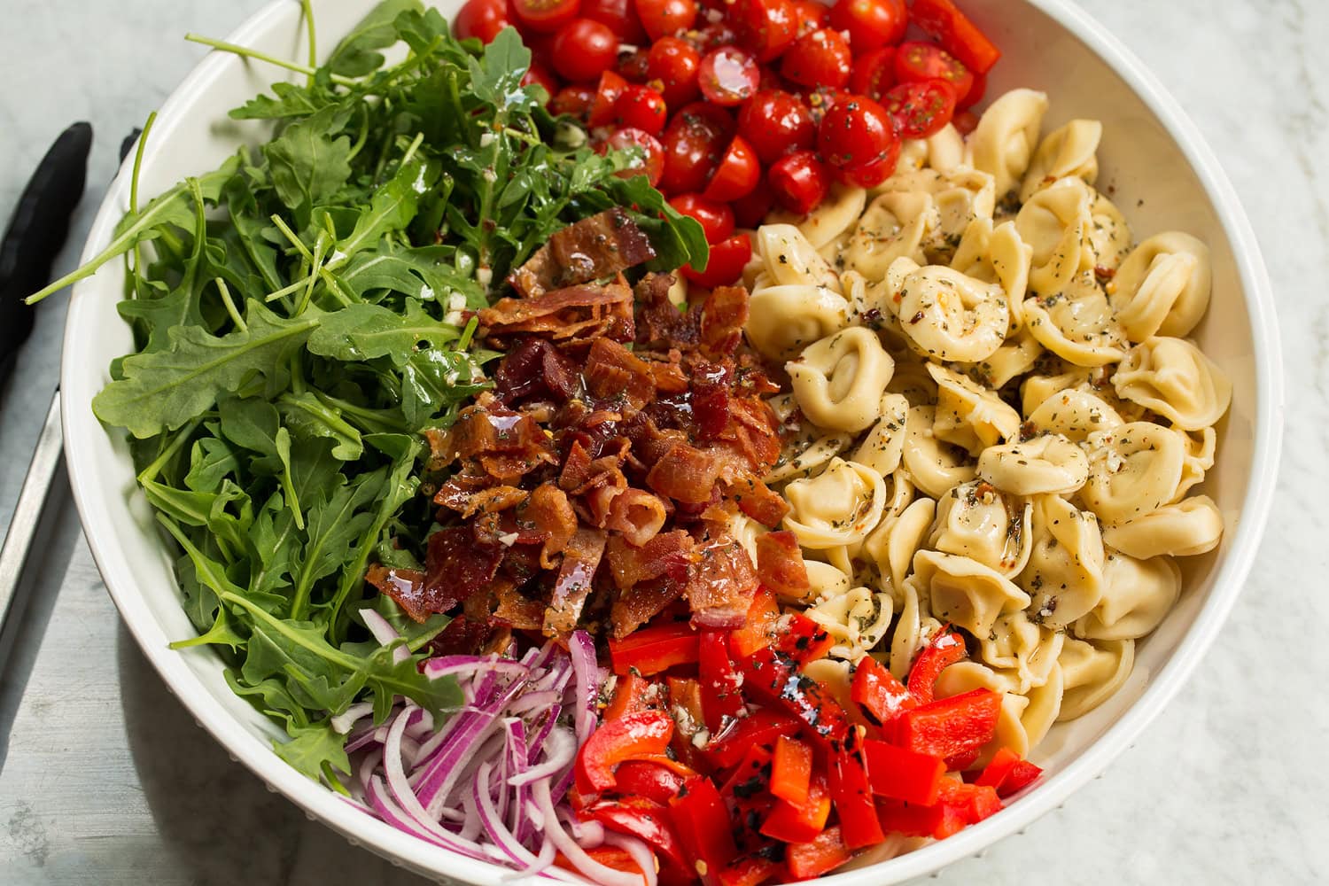 Ingredients for pasta salad shown before tossing.