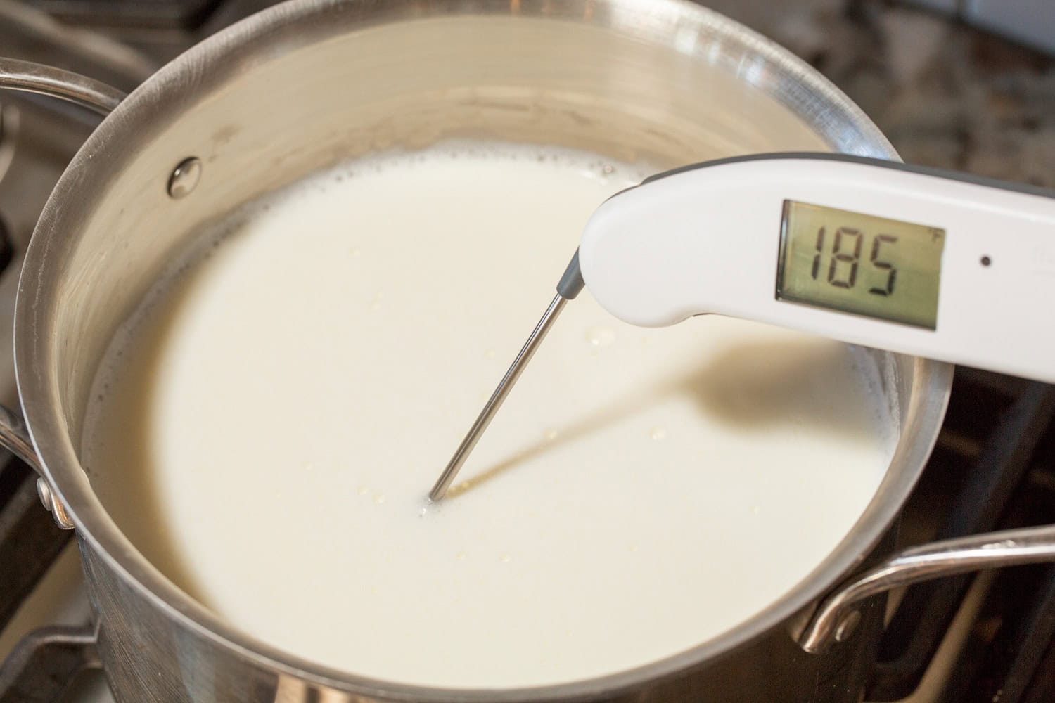 Milk heated in pot to 185 degrees.